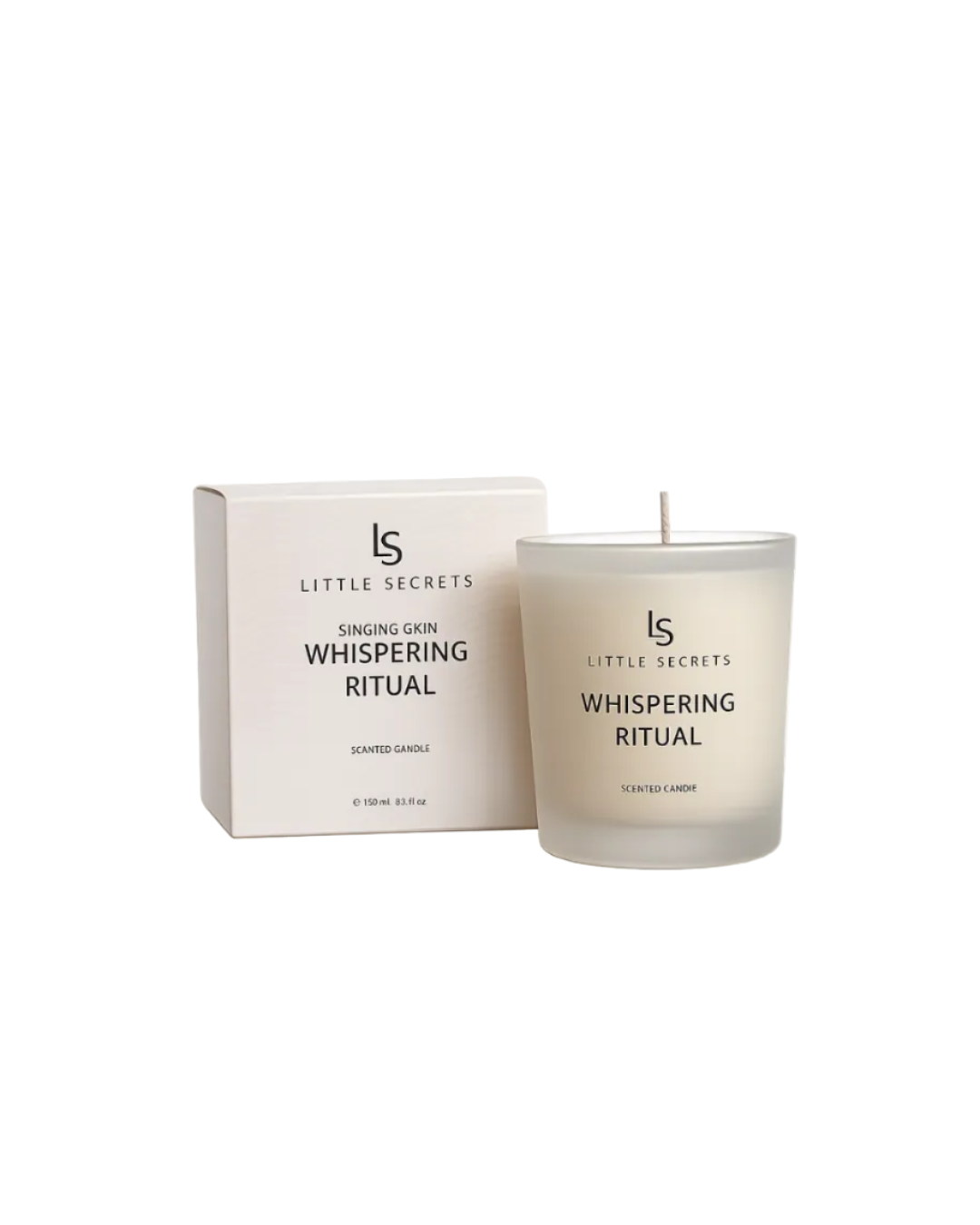 A frosted glass scented candle with a single wick stands next to its matching cream-colored packaging box. Both items feature black text reading 'LS LITTLE SECRETS WHISPERING RITUAL'.