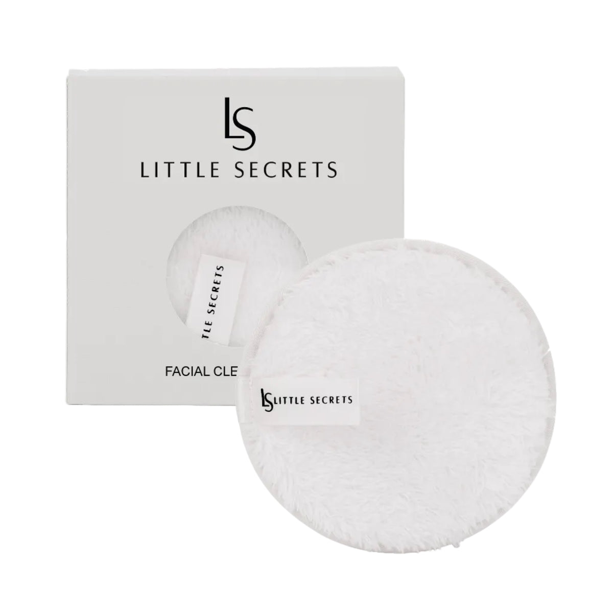 Two round white fluffy facial cleansing pads with a small white tag printed with the 'LS LITTLE SECRETS' logo, shown in front of their white packaging box.