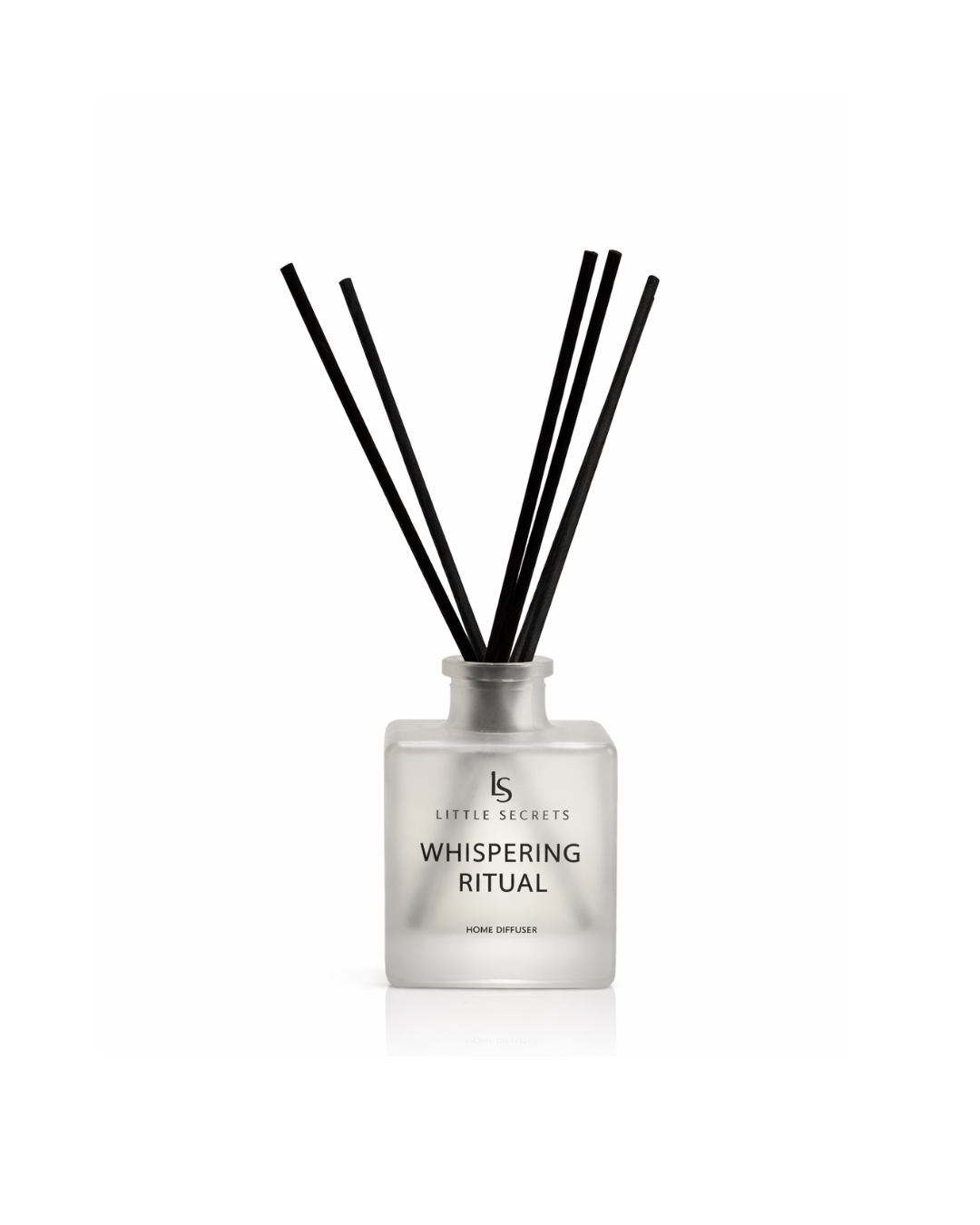 A reed diffuser bottle with a frosted glass body and six black reeds, labeled 'Little Secrets Whispering Ritual' on a clean white background.